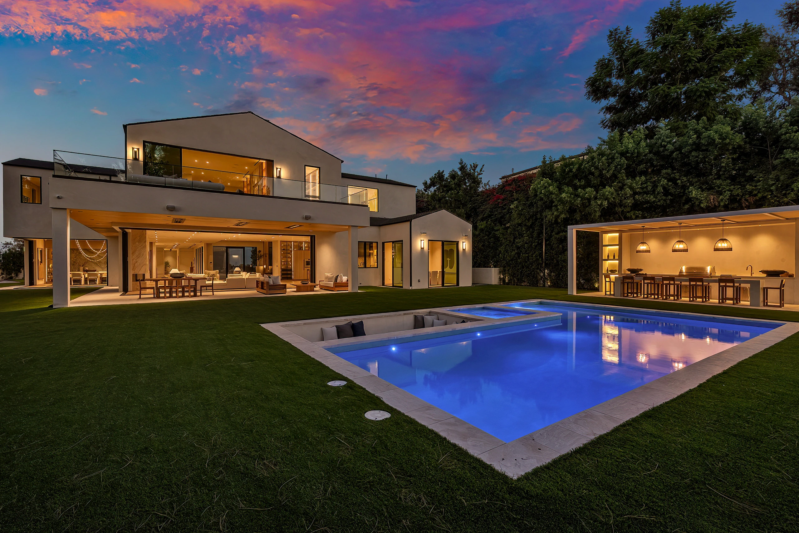 The pool and rear elevation at twilight