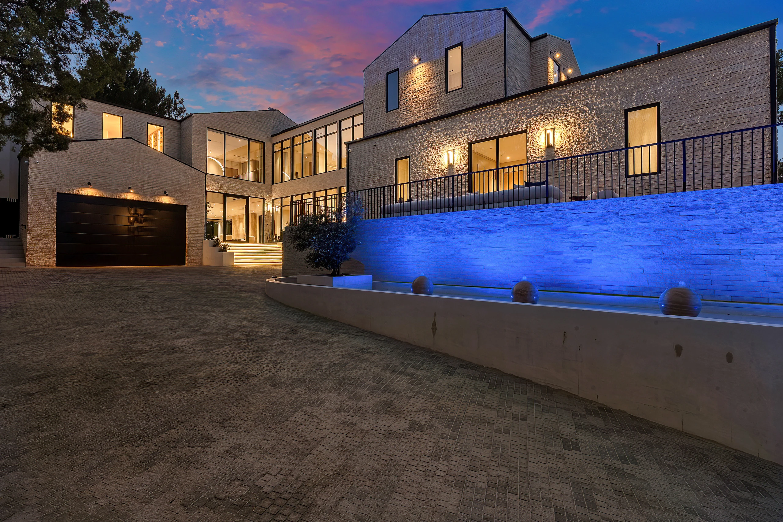 The front courtyard and illuminated stone facade at night