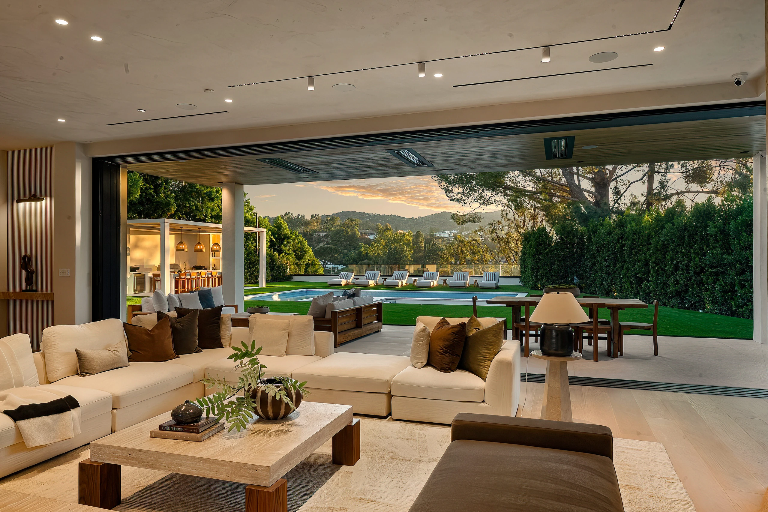 The family room looking toward the pool at sunset