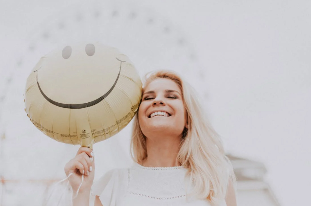 Woman smiling wearing a sunhat at a fair