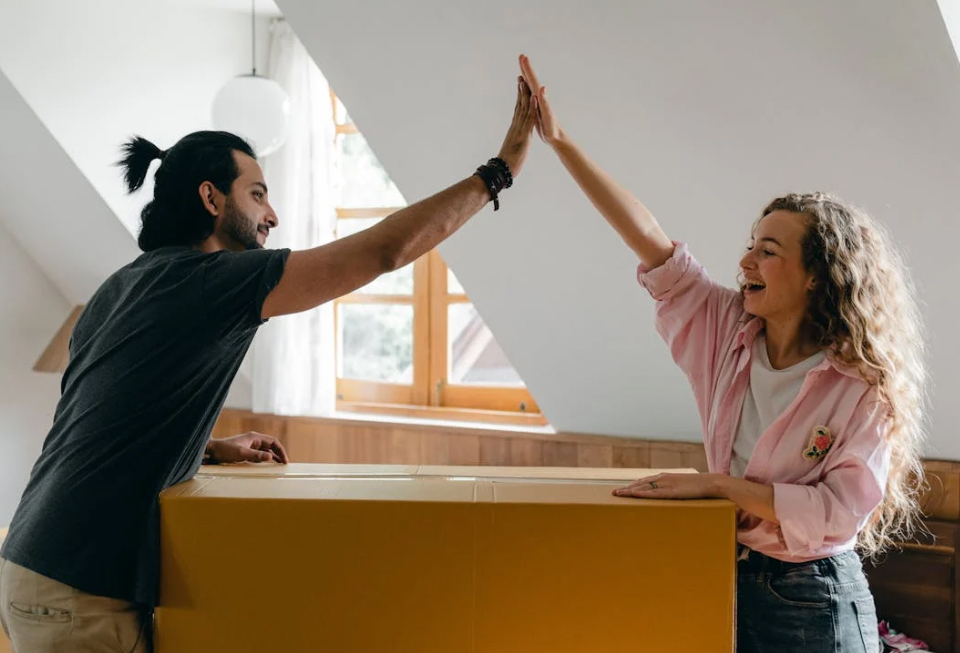 Couple practicing yoga together at home