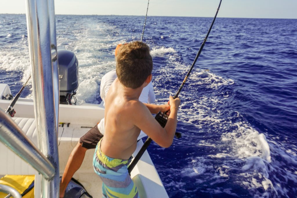 fishing in belize boy catching fish