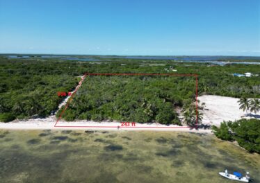 Aerial view of beachfront land in San Andres, Ambergris Caye, with outlined lot area showing 243' oceanfront and 586' depth, highlighting the property's prime location