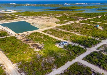 Aerial view of build-ready 70x100 lot in Secret Beach Belize real estate market