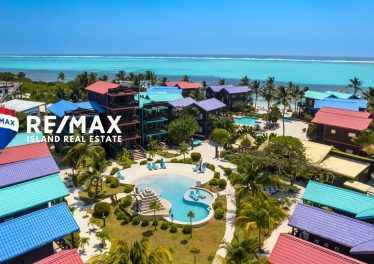 Aerial view of X’tan Ha Resort on Ambergris Caye showing beachfront condos, pool, dock, and turquoise Caribbean waters