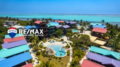 Aerial view of X’tan Ha Resort on Ambergris Caye showing beachfront condos, pool, dock, and turquoise Caribbean waters
