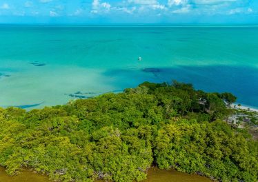 Aerial view of 2.4-acre beachfront property at Secret Beach, Ambergris Caye, showing over 250 feet of Caribbean Sea frontage and buildable high land