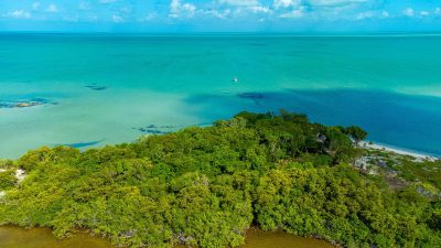 Aerial view of 2.4-acre beachfront property at Secret Beach, Ambergris Caye, showing over 250 feet of Caribbean Sea frontage and buildable high land