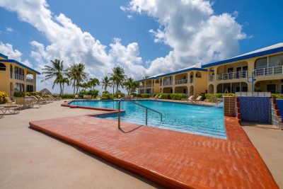 Garden-view Ambergris Caye condo at Royal Palm Villas with pool and direct beach access.