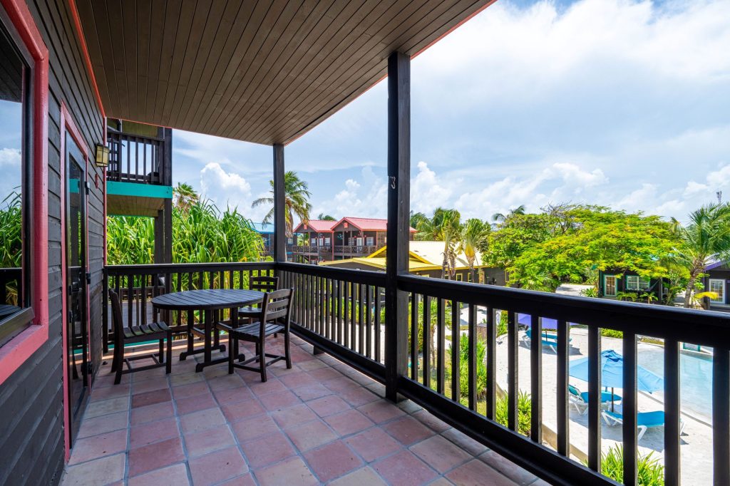 Furnished 2-bedroom Ambergris Caye condo at X’TAN HA Resort with balcony views, pools, and beachfront access.