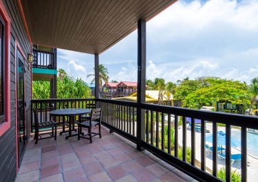 Furnished 2-bedroom Ambergris Caye condo at X’TAN HA Resort with balcony views, pools, and beachfront access.