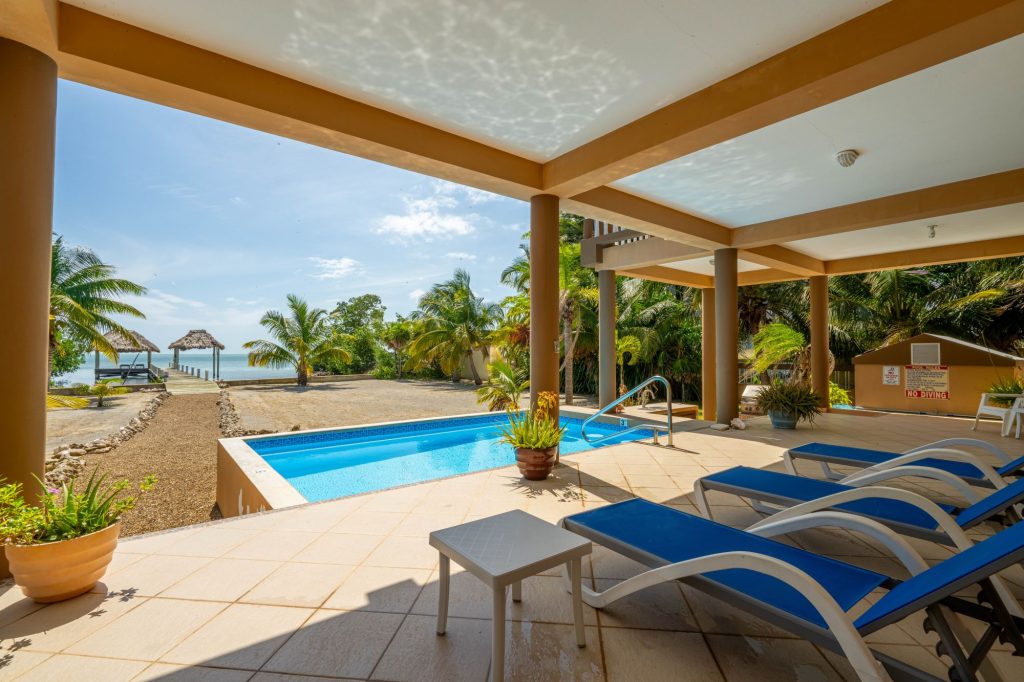 Oceanfront Belize home with private pool, palm trees, and sea views at Seaside Casa in Ambergris Caye.