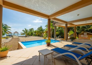 Oceanfront Belize home with private pool, palm trees, and sea views at Seaside Casa in Ambergris Caye.