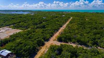 Four adjacent lots near Secret Beach, Ambergris Caye. Prime location, off-grid potential, low taxes. Exceptional Belize real estate investment opportunity.