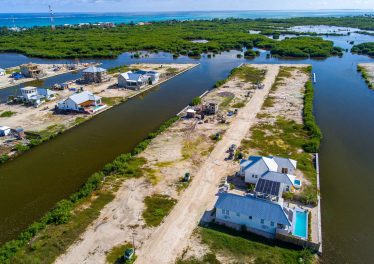 Aerial view of Mahogany Bay canal lots for sale in Phase 2 showing wide waterfront canals.