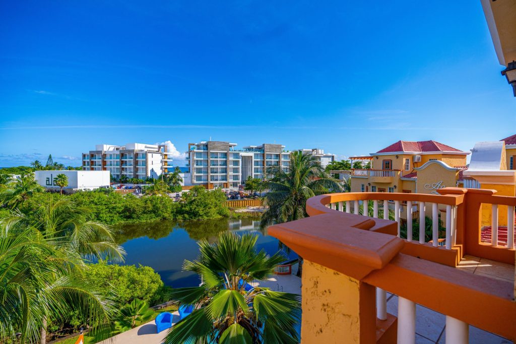 View from the condo balcony overlooking the pool and lake at Ambergris Lake Villas in San Pedro, Belize