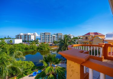 View from the condo balcony overlooking the pool and lake at Ambergris Lake Villas in San Pedro, Belize