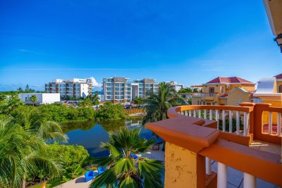 View from the condo balcony overlooking the pool and lake at Ambergris Lake Villas in San Pedro, Belize