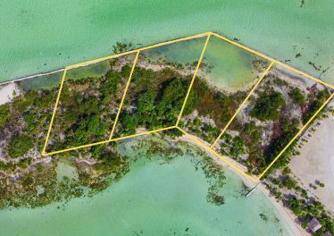 Aerial view of four beachfront lots for sale on the west coast of Ambergris Caye, Belize