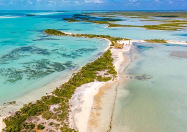 Secret Beach Ambergris Caye sea to lagoon lot aerial view showing Caribbean beachfront and lagoon frontage Belize real estate for sale