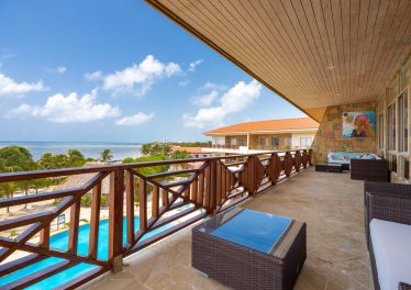 Spacious covered oceanfront veranda offering elevated Caribbean Sea and Belize Barrier Reef views from Oceans 23 penthouse on Ambergris Caye