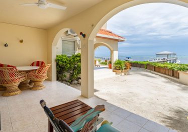 Ground floor private patio opening directly onto the beach at The Palms Oceanfront Suites Unit 11 in San Pedro Belize