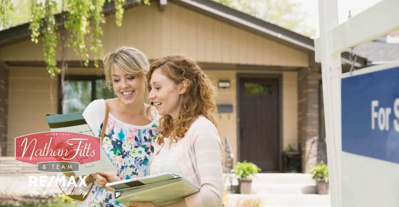 two women looking at the house's floor plan