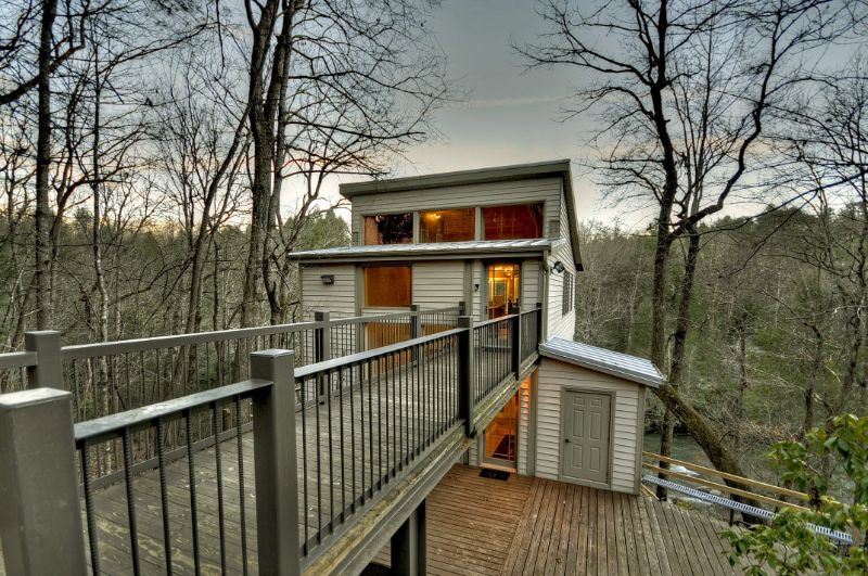 Wooden style house with dry tress on the background