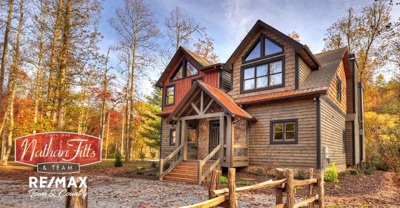 Wooden style house with dry trees in the background