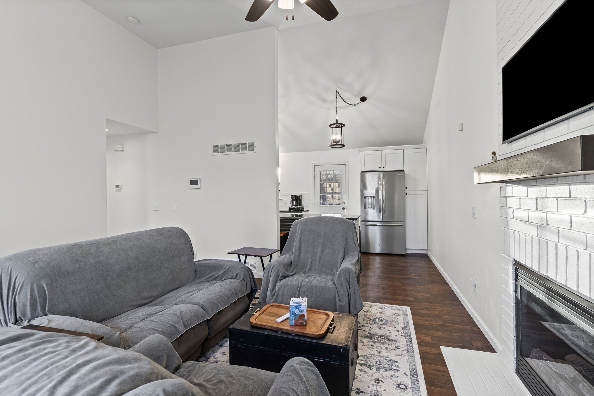 Open living and kitchen with stainless appliances