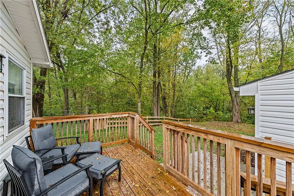 The covered deck overlooking the treed yard — 605 4th Street, Weston MO