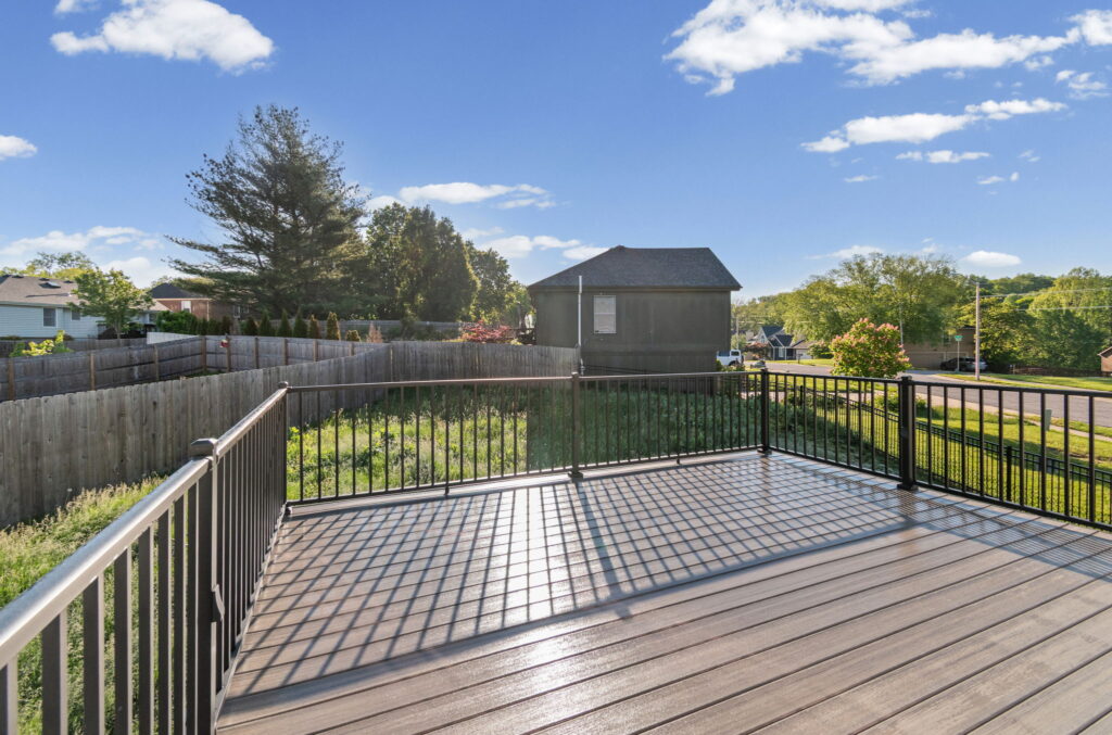 Spacious deck overlooking the fenced corner lot at 7205 N Hickory Street
