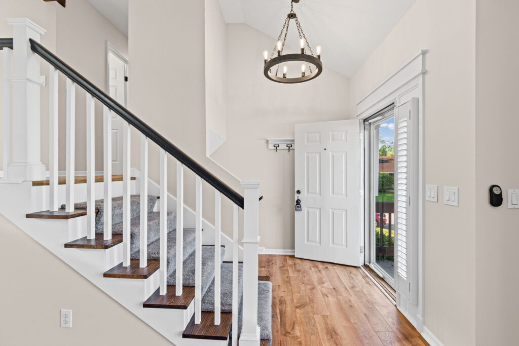 Vaulted entry with hardwood floors and a wall of natural light at 7205 N Hickory Street