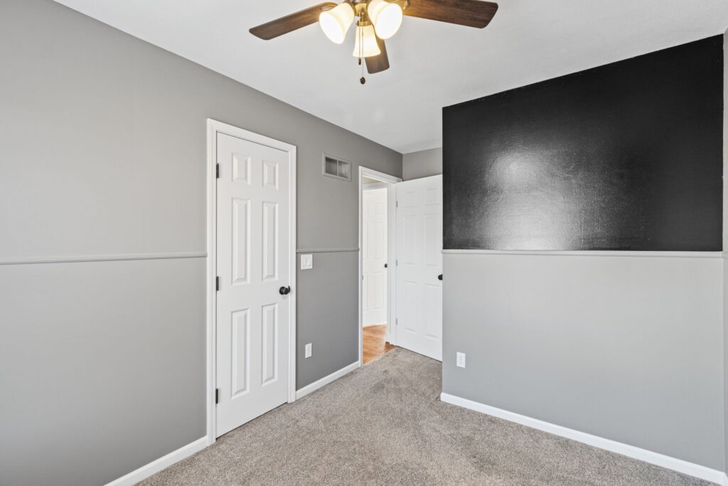 Secondary bedroom with fresh paint and a bright window at 7205 N Hickory Street
