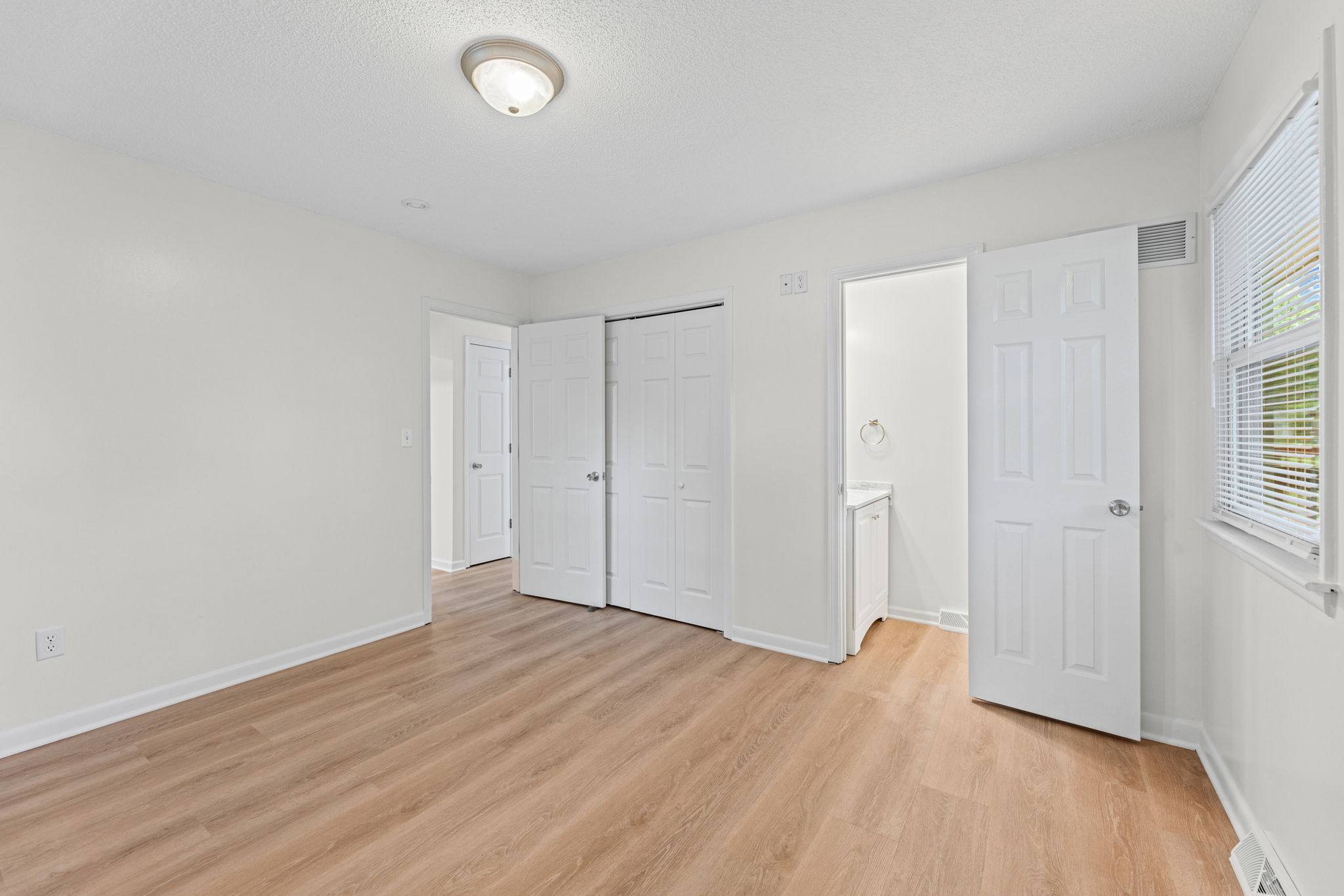 Primary bedroom with a private half bath — 119 Sherri Lane, Excelsior Springs, MO