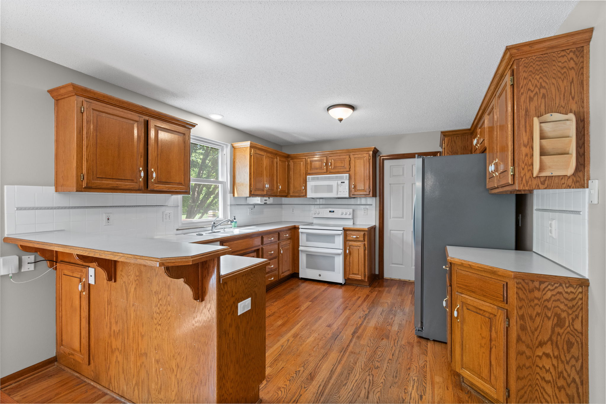 Kitchen with oak cabinetry and pantry at 15801 E 2nd Street S, Independence, MO