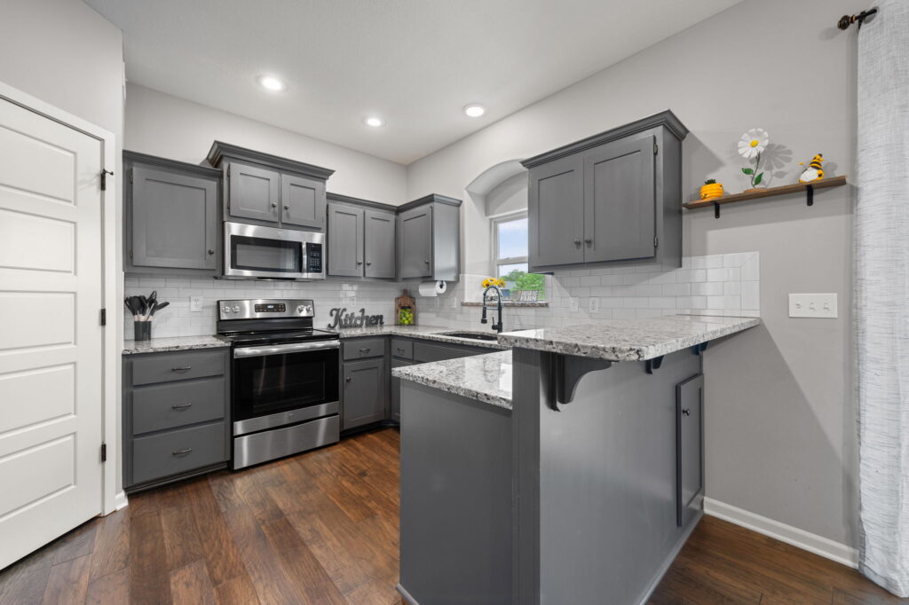 Updated kitchen with custom gray cabinets and granite at 11907 N Tracy Avenue