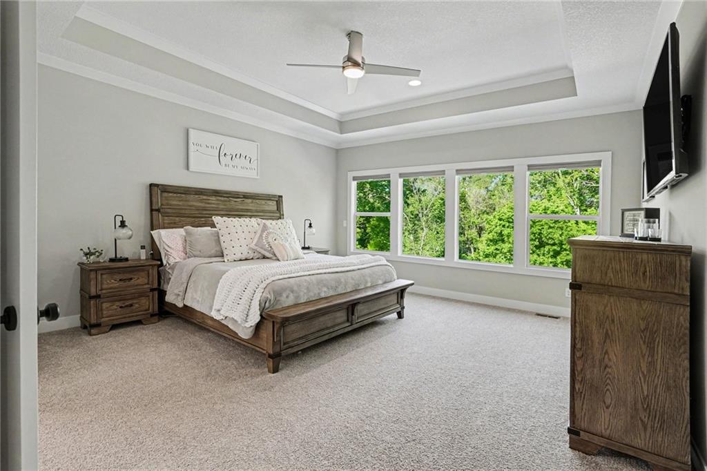 1784 Homestead Drive, Liberty MO — Main-level primary suite with a tray ceiling and treetop views.