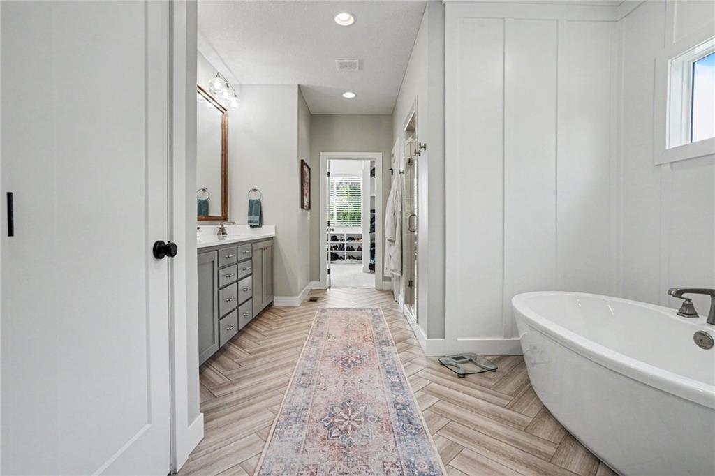 1784 Homestead Drive, Liberty MO — Spa primary bath with a freestanding soaking tub and walk-in closet.