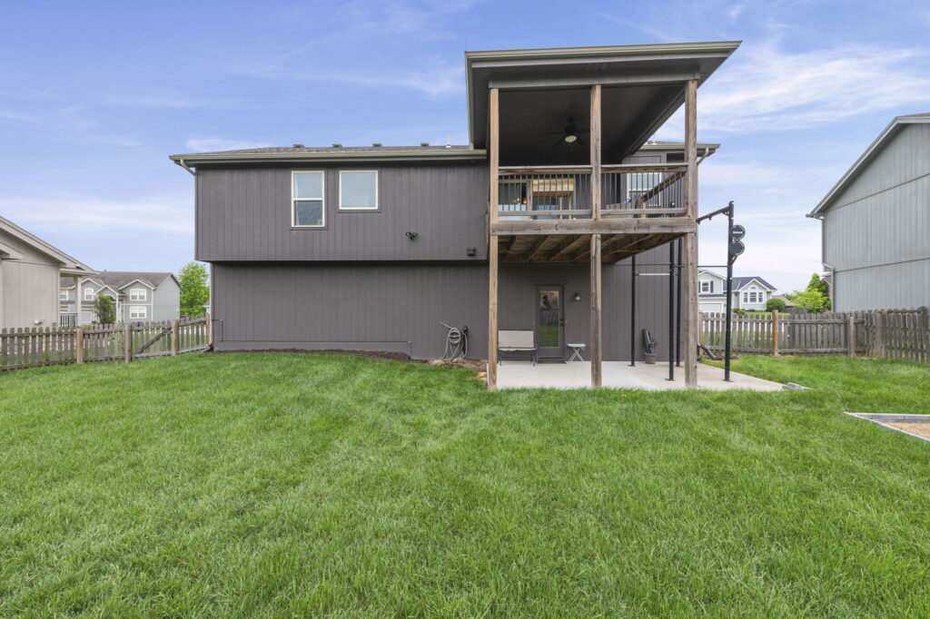 Covered deck and fully fenced backyard at 11907 N Tracy Avenue