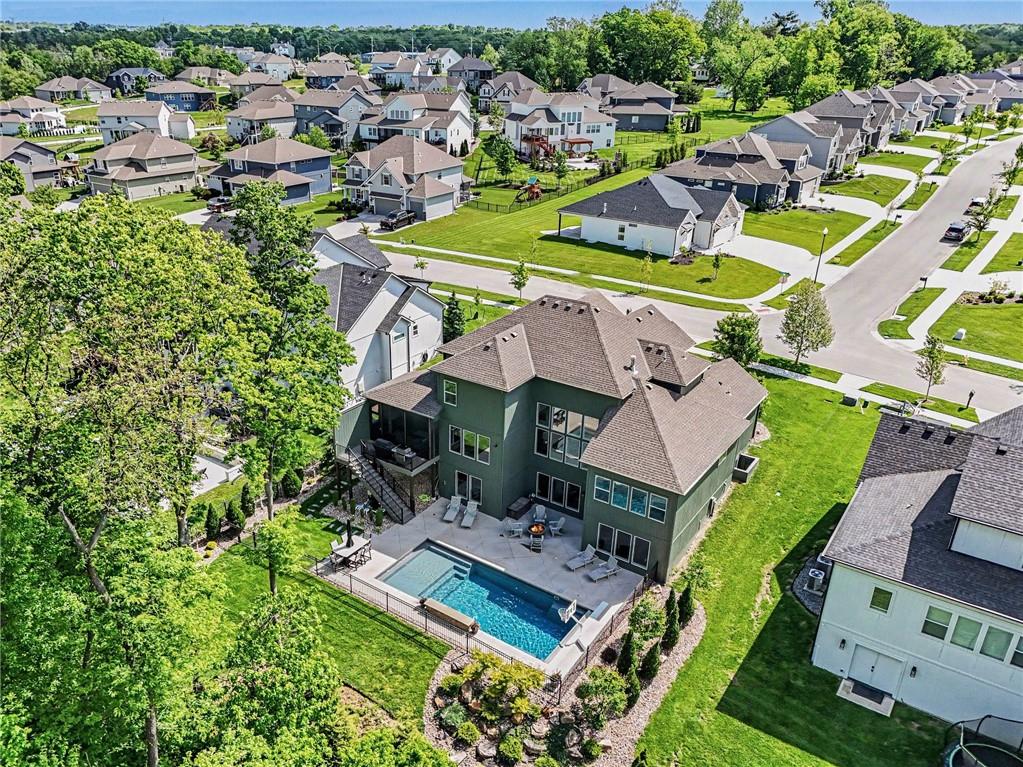 1784 Homestead Drive, Liberty MO — Aerial view — the home backs to mature woods, with the pool tucked below.