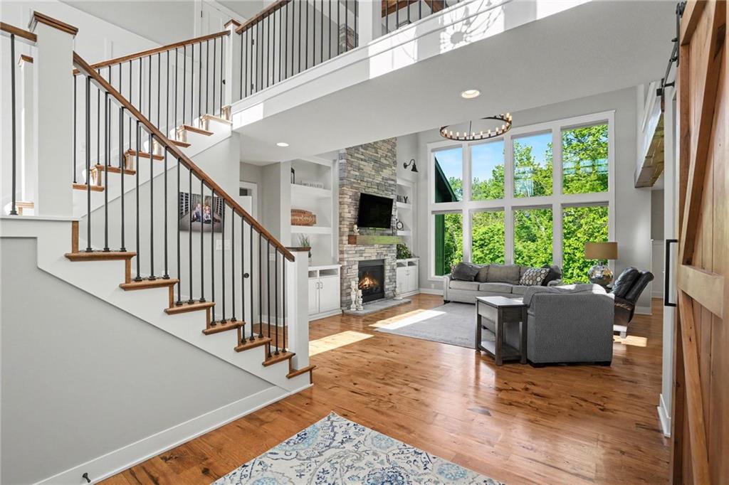1784 Homestead Drive, Liberty MO — Two-story great room with a stacked-stone fireplace.