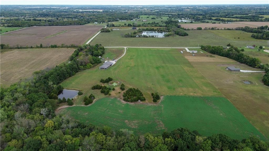 Countryside aerial with pond and pasture surrounding 114 SW 1451 Road, Holden, MO