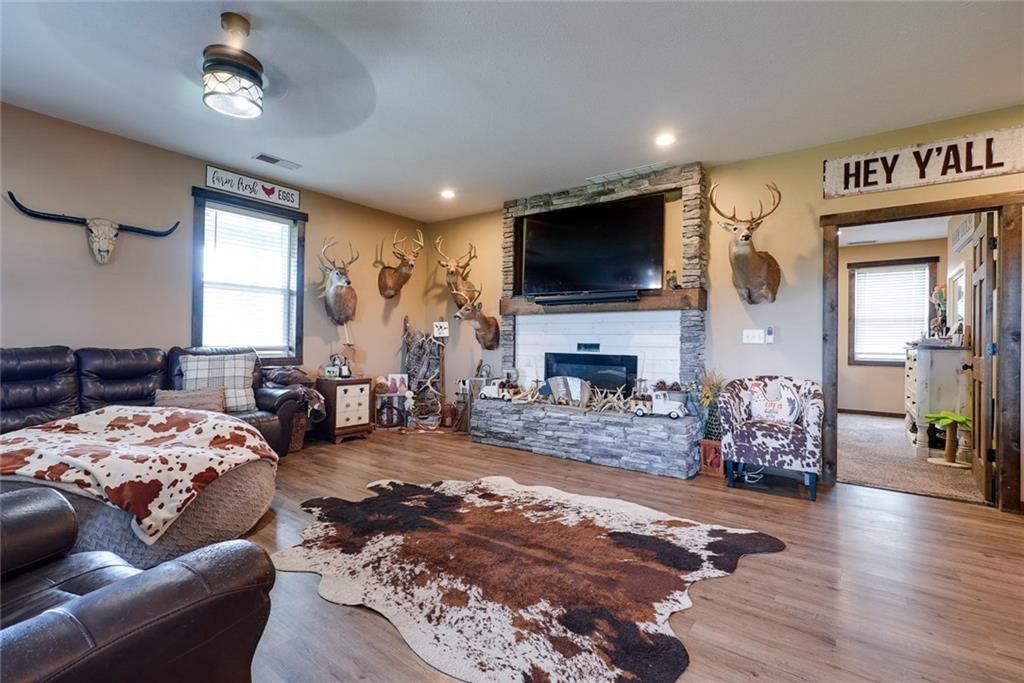 Living room with stone fireplace at 114 SW 1451 Road, Holden, MO