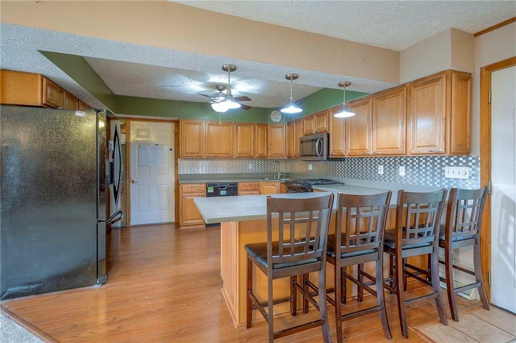 Updated kitchen with breakfast bar seating at 6509 NW Twin Oaks Drive