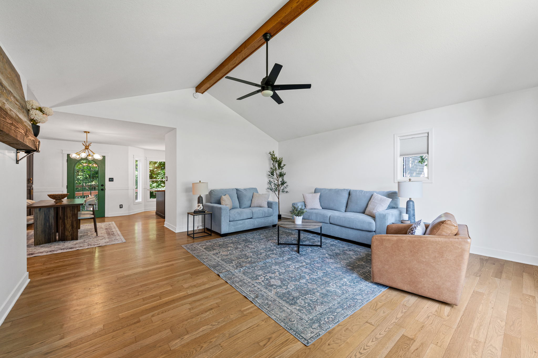 Vaulted living room with an exposed wood beam and hardwood floors in a Platte City, Missouri home