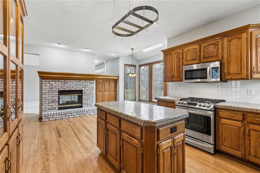 Granite kitchen with island and gas range, 1995 traditional home Parkville MO