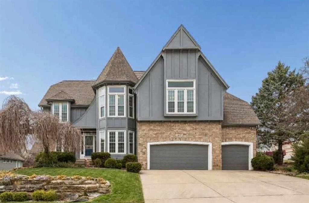 Front exterior of a 1995 traditional home on a corner lot in the Hills of Monticello, Parkville MO, bought before the wedding