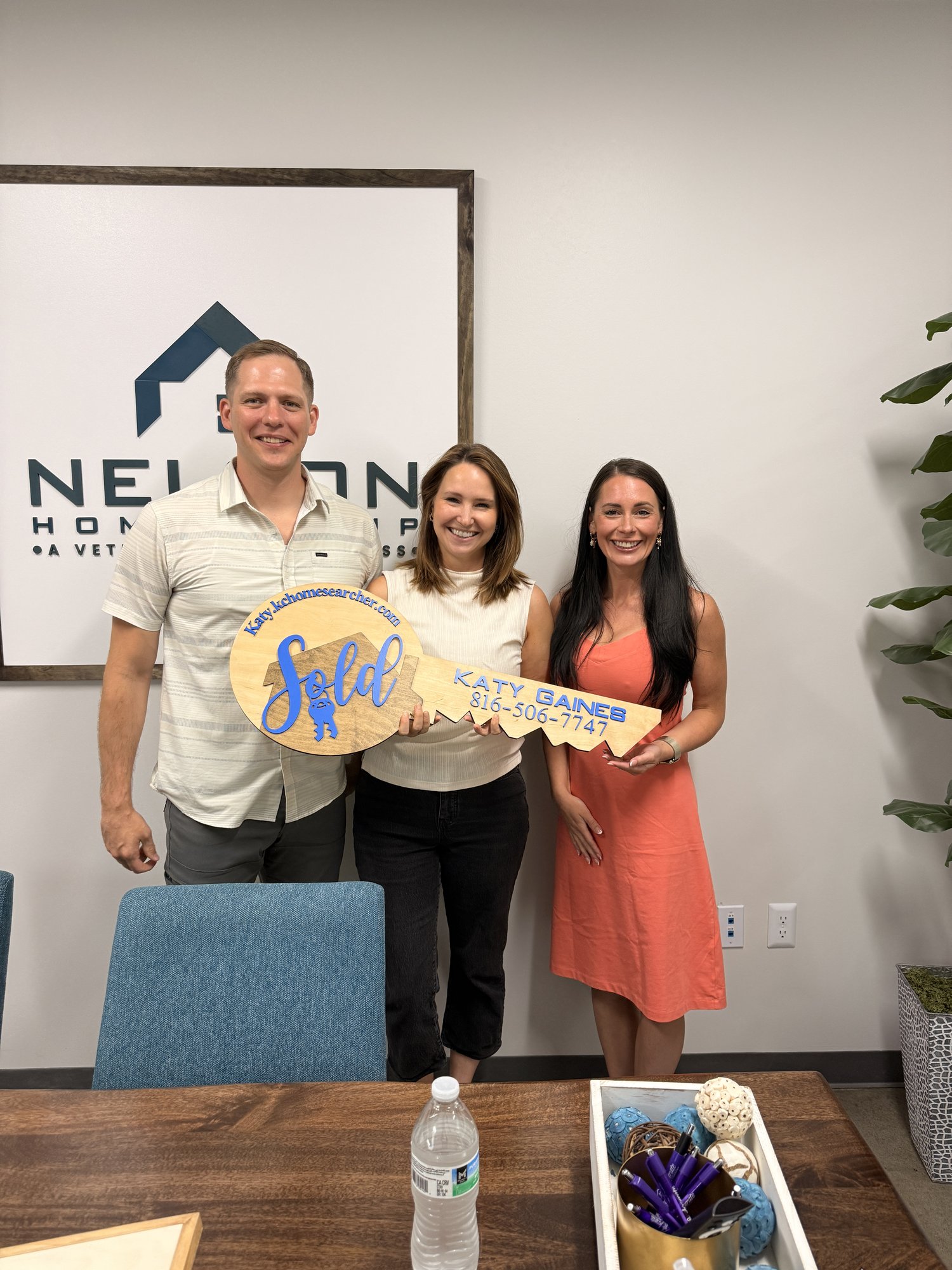 Jordan and Sarah with Nelson Home Group buyer's agent Katy Gaines holding the sold key on closing day for 626 Liberty Road, Smithville, MO