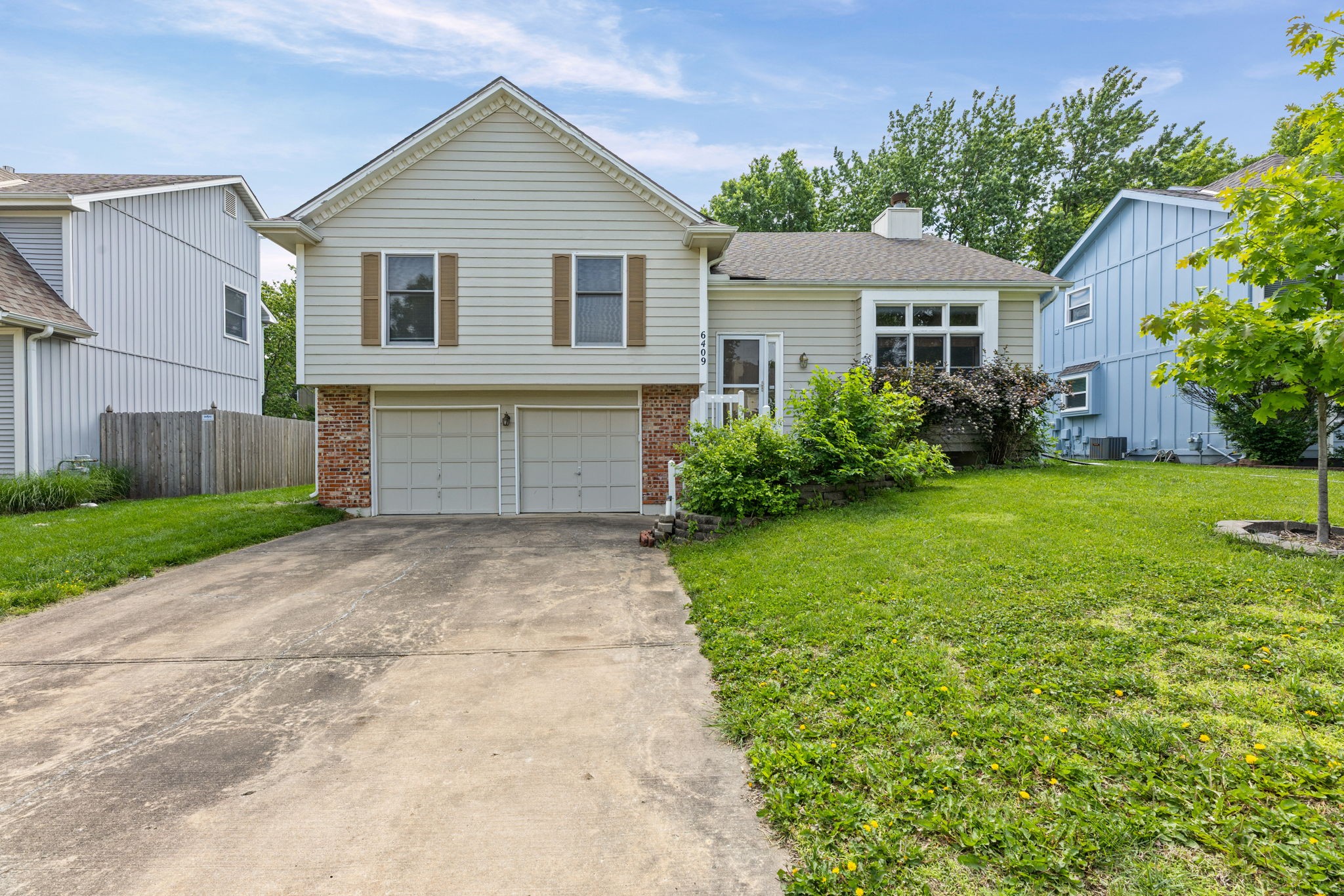 Front exterior of 6409 Chouteau Street, Shawnee, KS 66226 — front-to-back split in Woodland Park